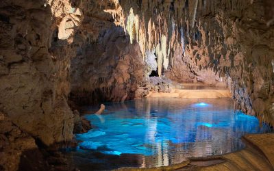 cave with calm body of water during daytime